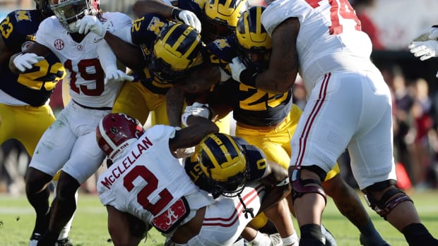Michigan Wolverines defensive back Mike Sainristil (0) tackles Alabama Crimson Tide running back Jase McClellan (2) in the second quarter in the 2024 Rose Bowl college football playoff semifinal game at Rose Bowl.